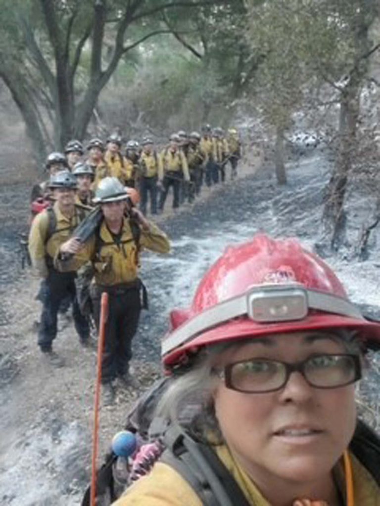 line of hikers yellow jackets - Sister Corps
